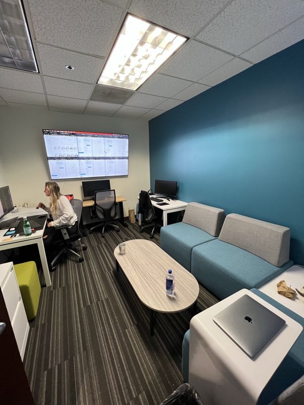 An operations room with wall-mounted dashboards and a team member working