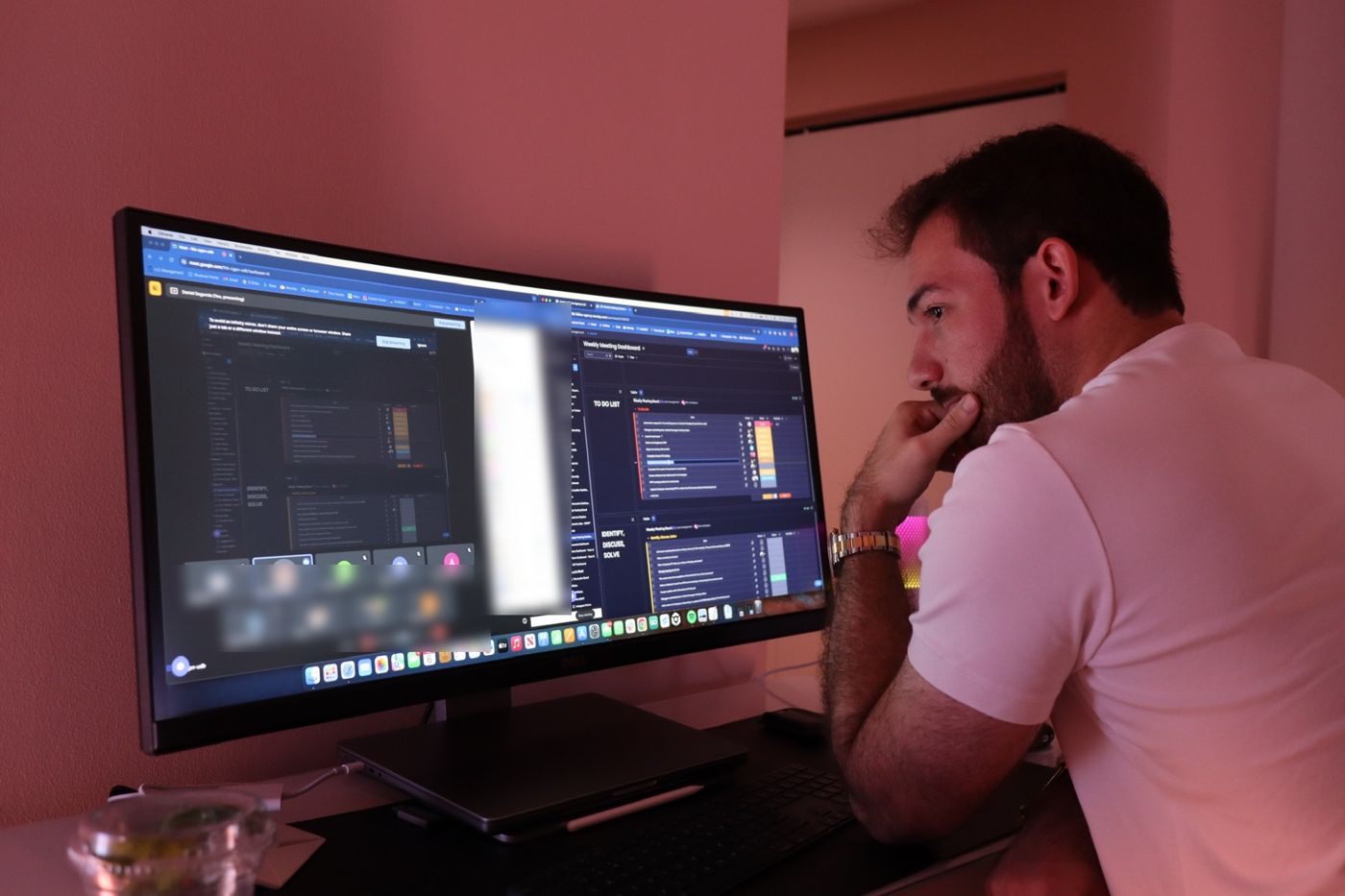 Daniel presenting a weekly meeting dashboard to the team on a video call, with a to-do list and an identify, discuss, solve board on screen